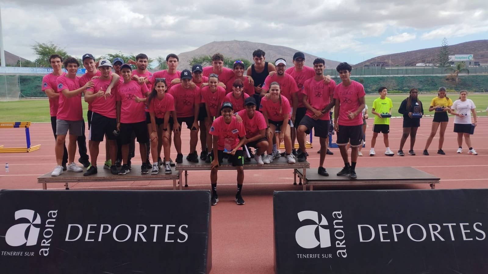 Noticias

Final del ‘Practicamos Atletismo’ en el estadio Antonio Domínguez de Playa de Las Américas

300 estudiantes de la comarca sur de Tenerife participan en la final del programa para el alumnado de Enseñanza Secundaria de Arona, Granadilla, San Miguel y Guía de Isora

El IES Montaña Guaza se coronó campeón en la clasificación general femenina, mientras que el IES Manuel Martín González ganó en el apartado masculino.

El Estadio Antonio Domínguez de Playa de Las Américas se convirtió en el escenario del programa ‘Practicamos Atletismo’ del Patronato de Deportes del Ayuntamiento de Arona acogiendo la última jornada del programa. Un total de 300 alumnos y alumnas de Institutos de Enseñanza Secundaria (IES) de los municipios de Granadilla, Arona, San Miguel y Guía de Isora participaron en esta jornada final, cuyo objetivo principal es promover el conocimiento y la práctica de las distintas pruebas del atletismo.

El evento estuvo dirigido a estudiantes de las categorías sub 14 y sub 16, quienes se midieron en pruebas como los 80 metros lisos, 800 metros lisos, salto de longitud, lanzamiento de peso y relevos 5×80 metros. Además de fomentar la práctica deportiva, el programa buscó promover la convivencia entre los distintos centros educativos a través del deporte.

Tras dos jornadas de competición, el IES Manuel Martín González (Guía de Isora) se coronó campeón en la clasificación general masculina, seguido del IES Montaña de Guaza y el IES San Miguel. Tras los puestos de honor y en las posiciones cuarta a la decimocuarta se clasificaron IES Ichasagua, IES Echeyde III, IES Los Cristianos, IES Magallanes, IES Médano, IES Alcalá, SIES Arona, IES Los Cardones, IES Luis Diego Cuscoy, IES Las Galletas e IES Granadilla.

En la categoría femenina, el IES Montaña de Guaza obtuvo el primer puesto, con el IES Manuel Martín González y el IES Echeyde III completando el podio. Detrás de estos equipos se clasificaron el IES Ichasagua, IES San Miguel, IES Los Cristianos, IES Médano, IES Alcalá, IES Las Galletas, IES Magallanes, IES Luis Diego Cuscoy, IES Los Cardones, SIES Arona e IES Granadilla.

Una de las particularidades de este programa es la colaboración activa del alumnado del Ciclo Superior de Enseñanza y Animación Sociodeportiva del IES Las Galletas. Estos estudiantes desempeñaron funciones de organización y control de las pruebas, poniendo en práctica los conocimientos adquiridos en sus estudios y sumando experiencia a su formación profesional.

El programa ‘Practicamos Atletismo’ ha sido un ejemplo de cómo la colaboración entre instituciones educativas y municipales puede promover el deporte base. Este proyecto está diseñado para que los estudiantes conozcan y experimenten las distintas pruebas que conforman el atletismo, desde la velocidad hasta los lanzamientos, fomentando así su interés y comprensión por este deporte. La implicación de estos institutos refuerza el compromiso de la comarca sur de Tenerife con el deporte escolar y sus valores.